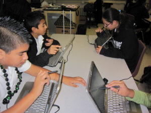 Students Working with laptops in school Students Working with laptops in school