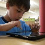 Student uses iPad for lesson.
