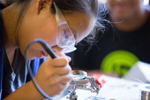 girl welding circuit board