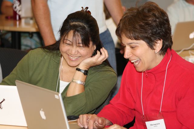 MERIT 2010 teachers collaborating on a laptop