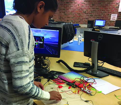 student working with wires hooked to circuit board